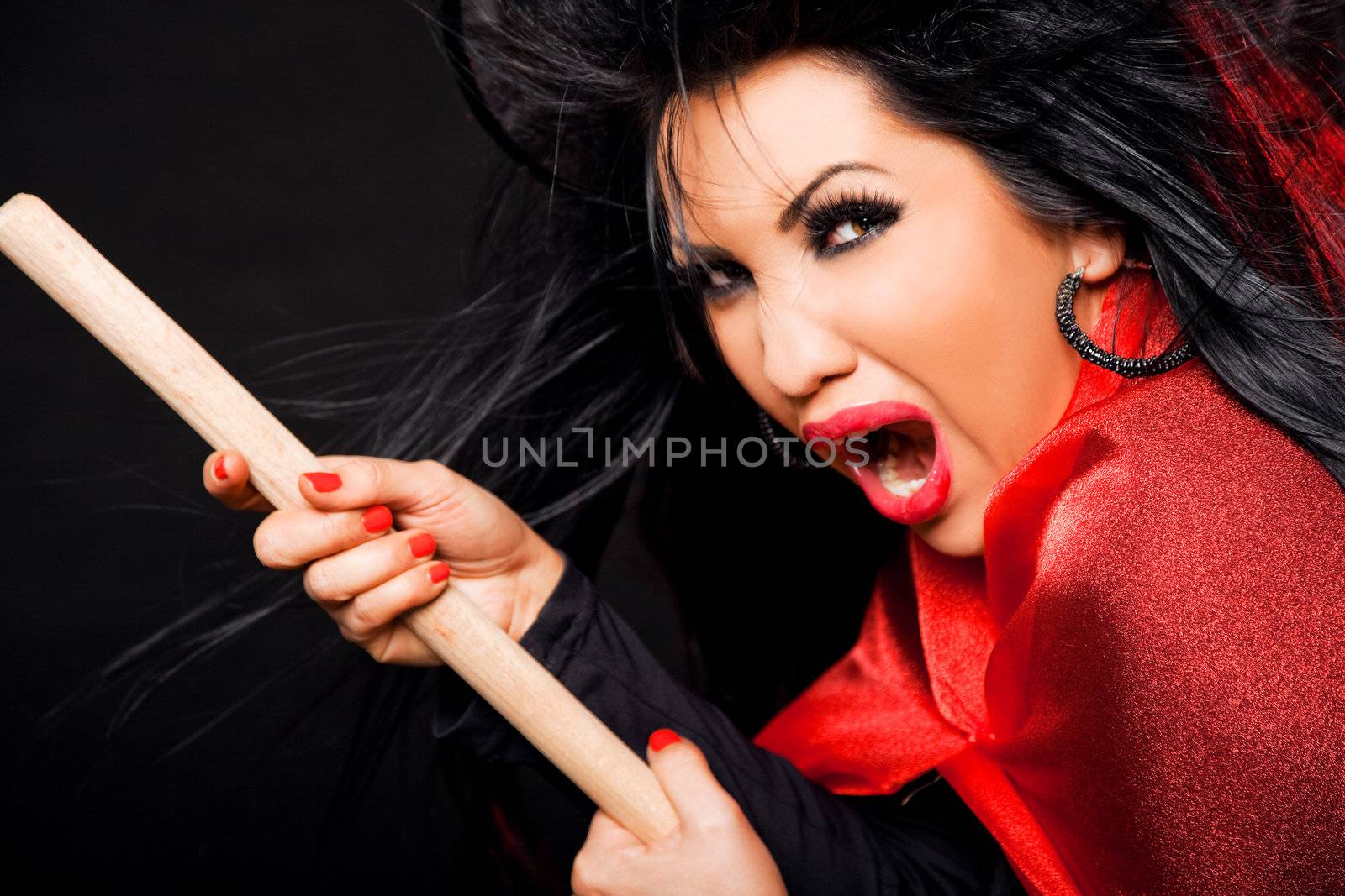 femalewitch with broomstick, looking scary and screaming