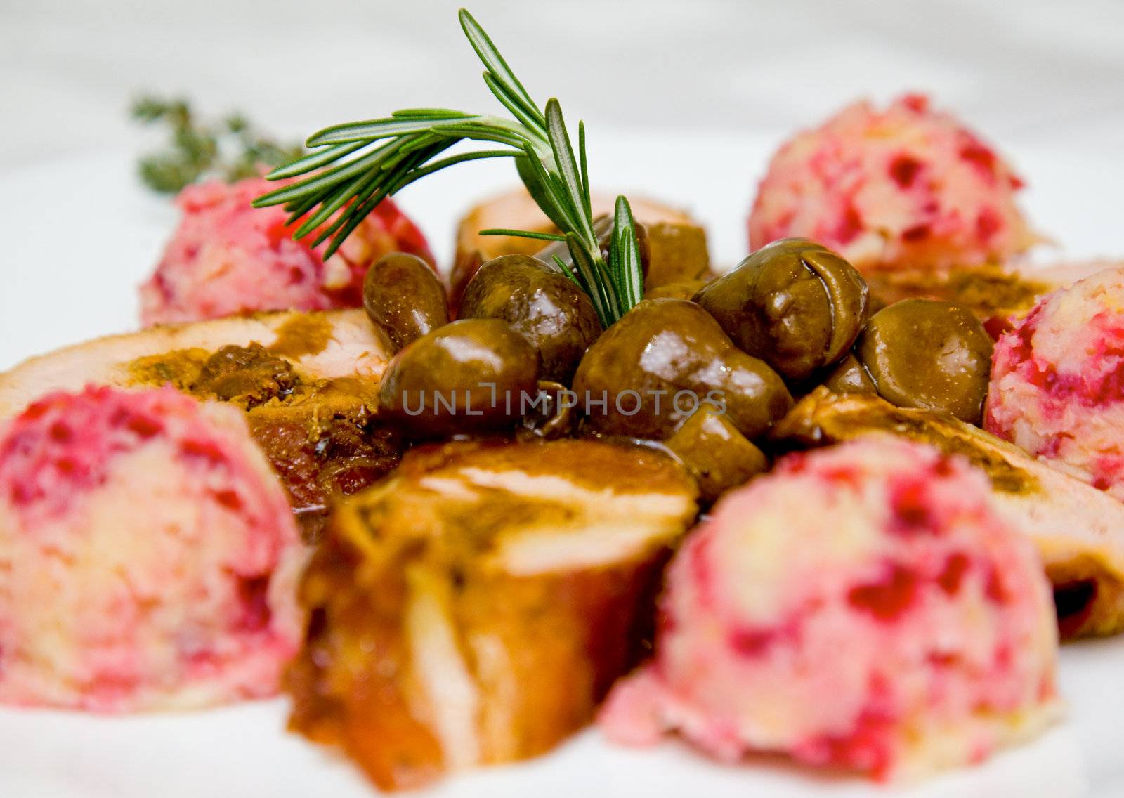 Close-up of pork fillet dish garnished with home made nougat ice cream