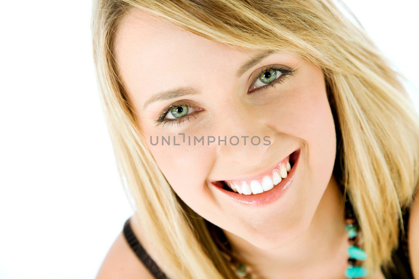 Close-up of happy blond female face smiling, looking at camera, isolated