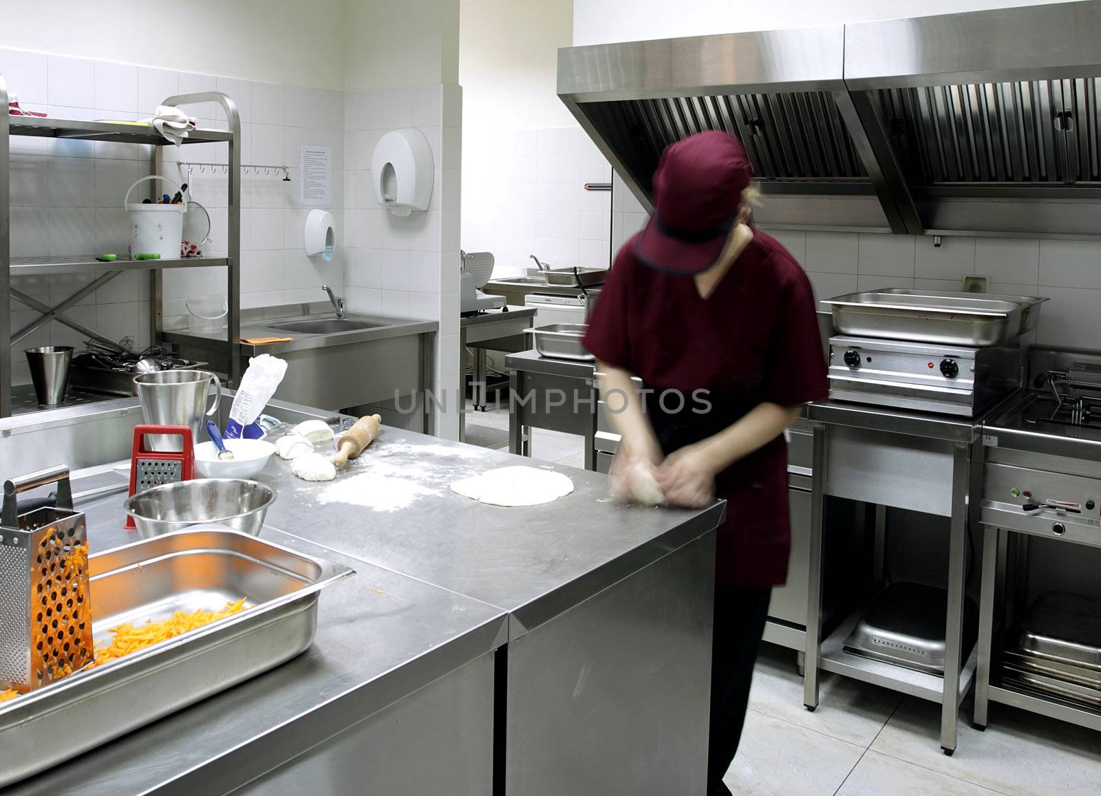 Cook in a restaurant kitchen by vilevi