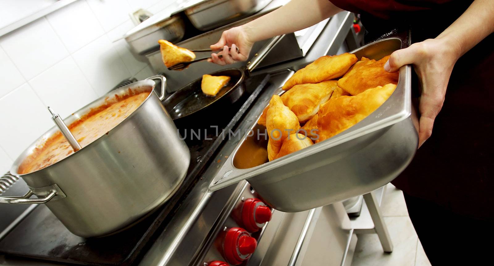 batter fried in a restaurant kitchen by vilevi