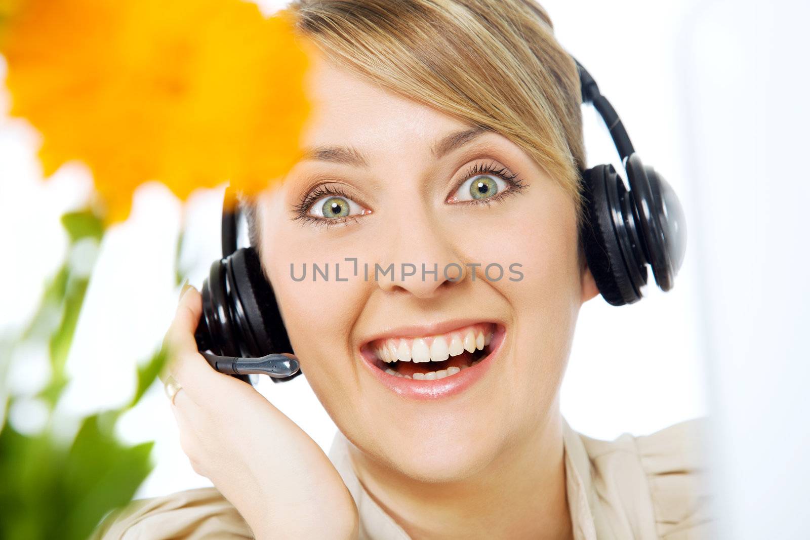 Portrait of beautiful smiling excited call center woman with headset