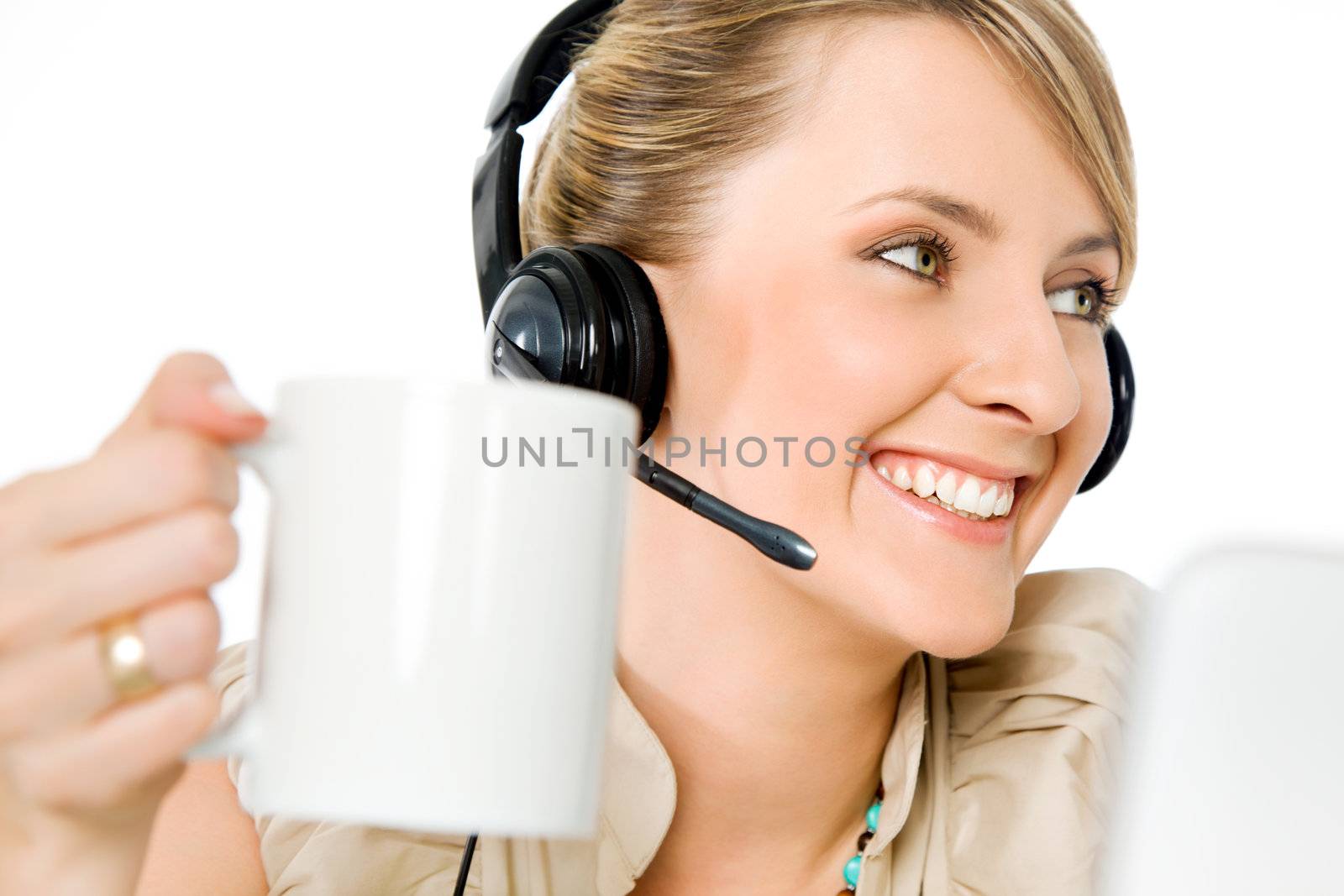 Portrait of beautiful smiling call center woman holding cup, looking left