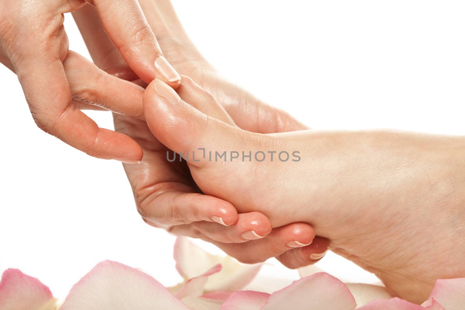 woman foot receiving gentle massage in a spa setting isolated