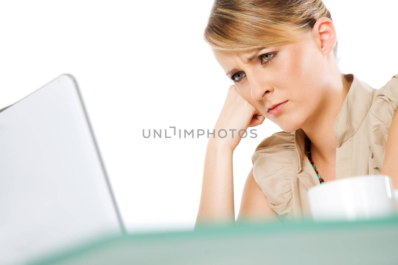 Portrait of beautiful blond woman behind laptop, looking upset or worried