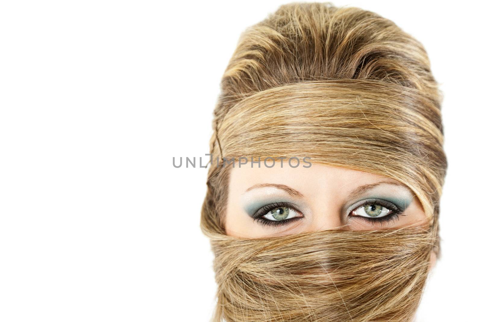 Fashion portrait of blonde female with excentric hairstyle all over her face