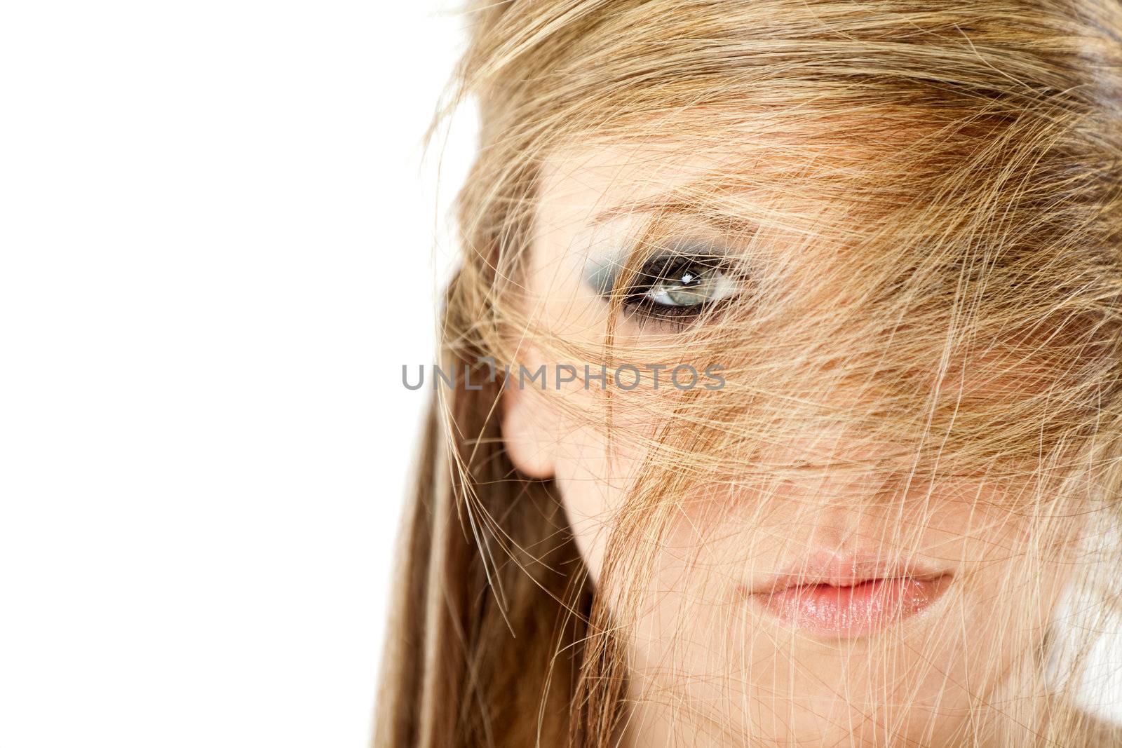 Close-up of blonde woman with hair all over her face, isolated on white