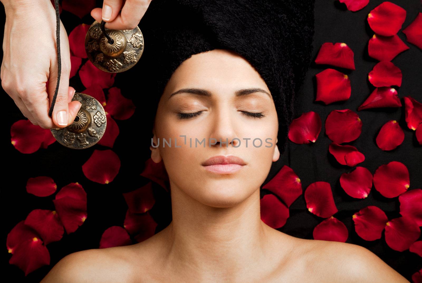 Close-up of beautiful female receiving energy sound massage at spa