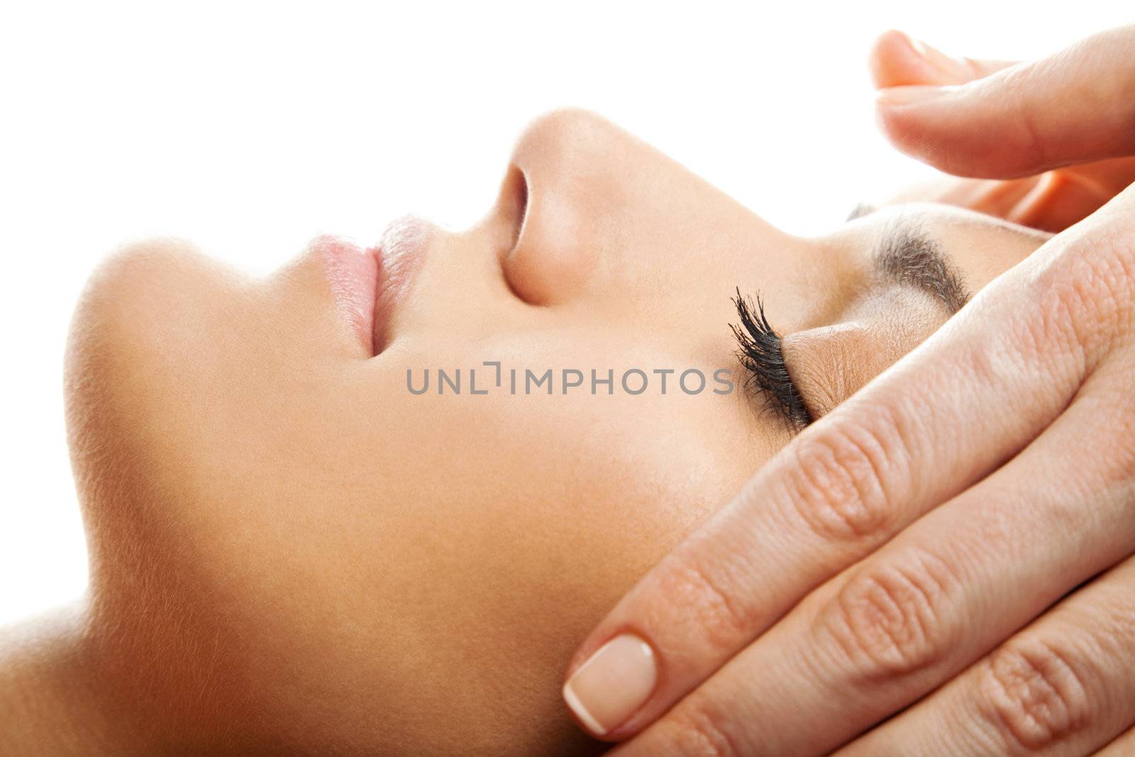 profile close-up of a beautiful woman face receiving massage isolated