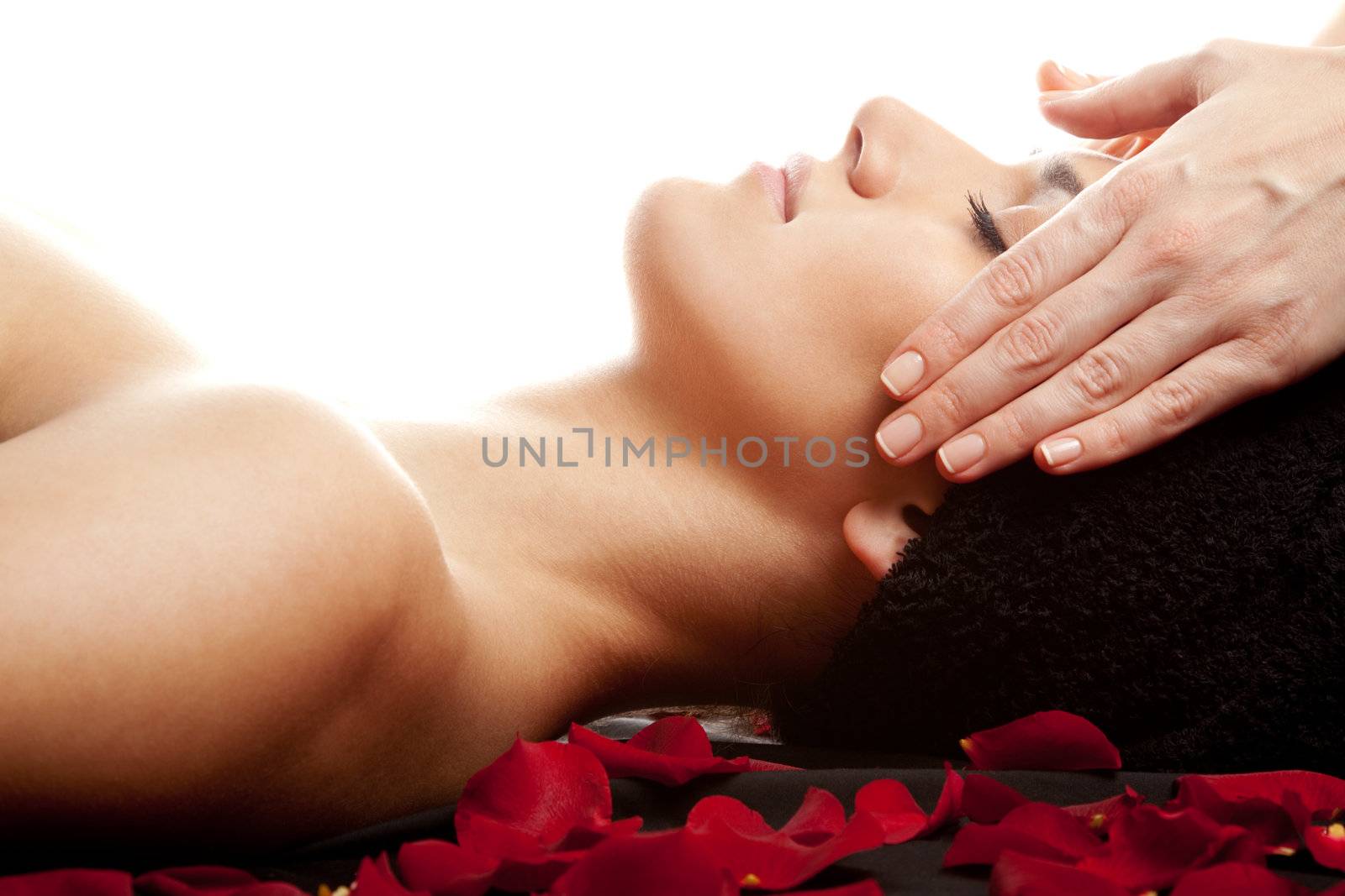 Young beautiful woman receiving a face massage at spa