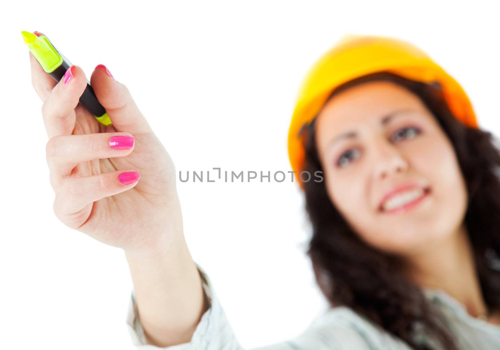 Young woman with construction's hardhat pointing with yellow marker, focus on hand