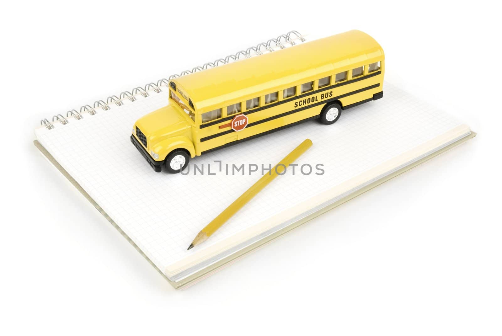 school bus and notebook with pen isolated on white background