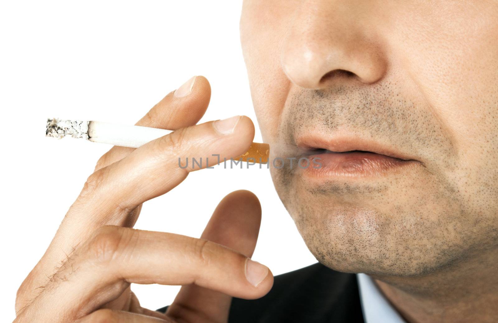 Cropped image of man holding cigarette in his hand, close-up on it and mouth
