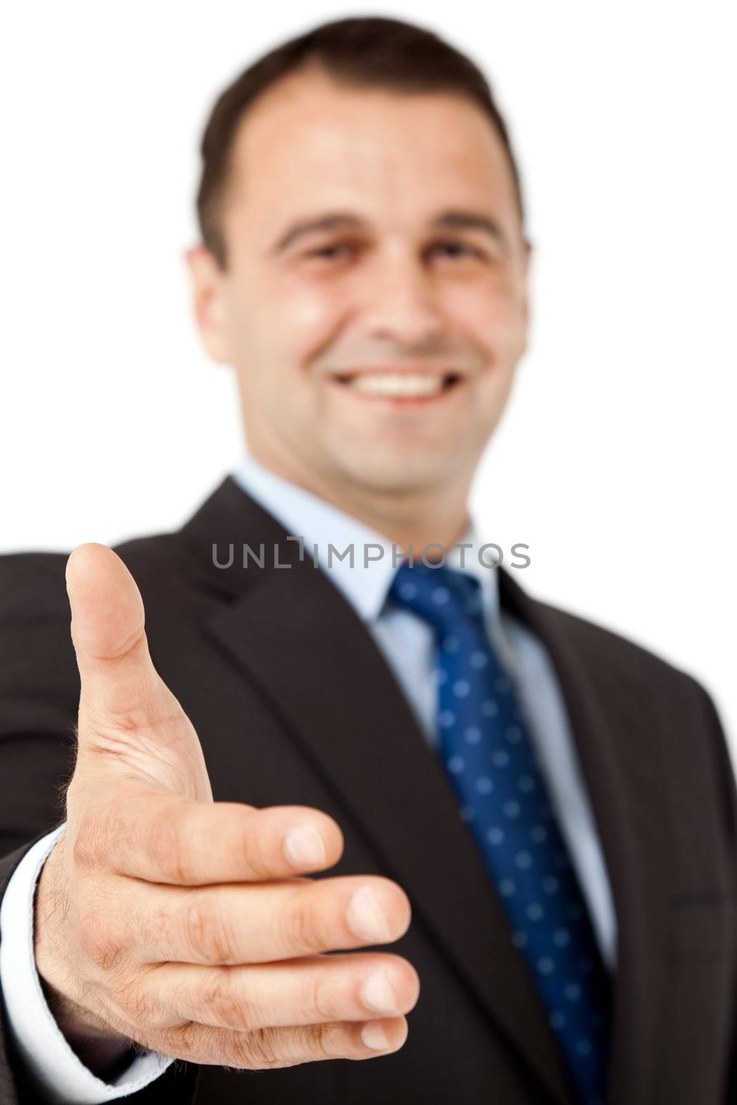 Smiling businessman offering handshake, selective focus on hand