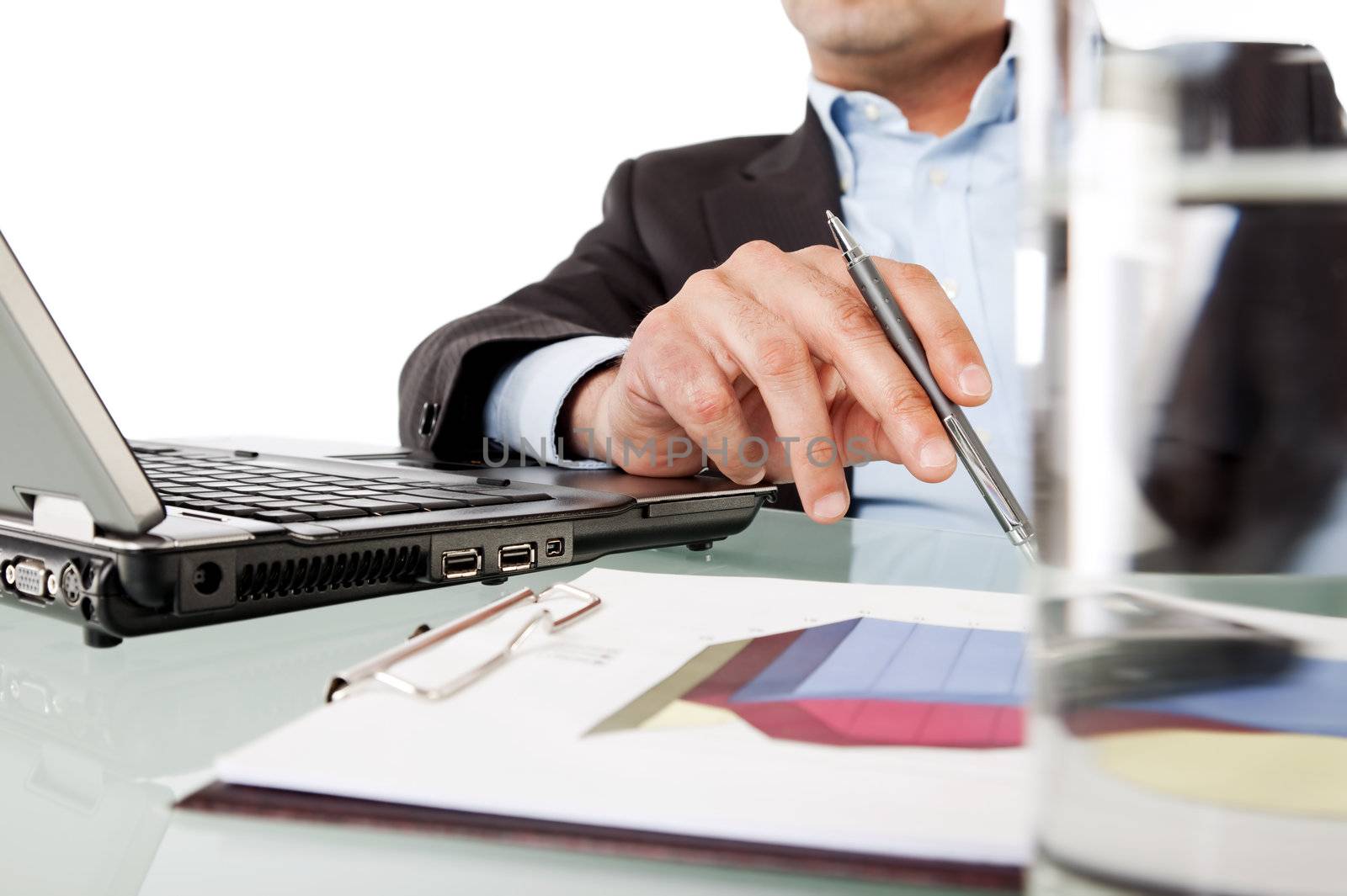 Close-up of businessman hand holding pen while working