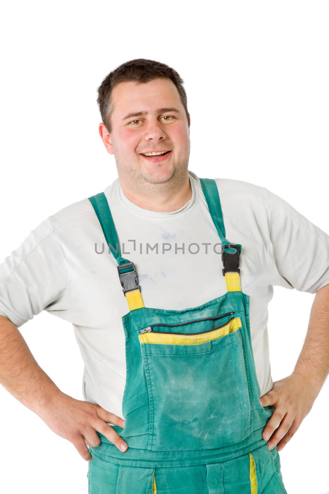 Close-up of smiling male worker posing with arms on waist, isolated