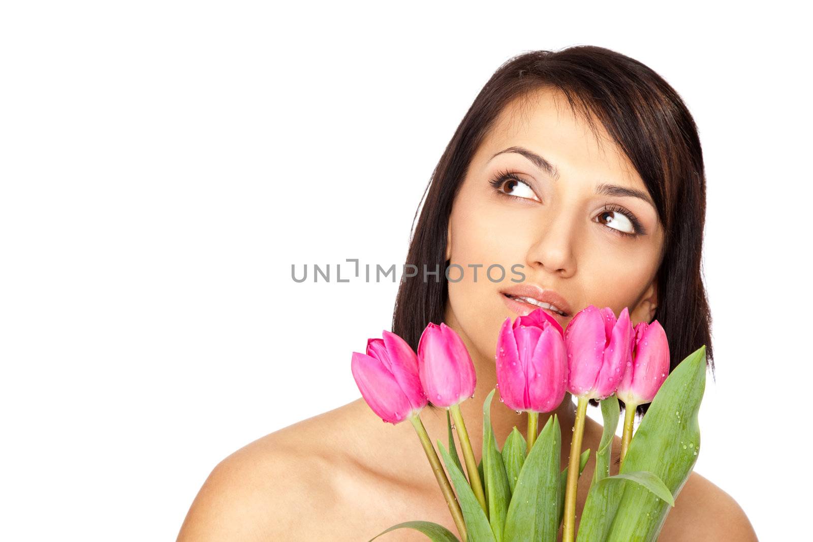 Beautiful naked shouders female holding a bunch of pink tulips isolated on white