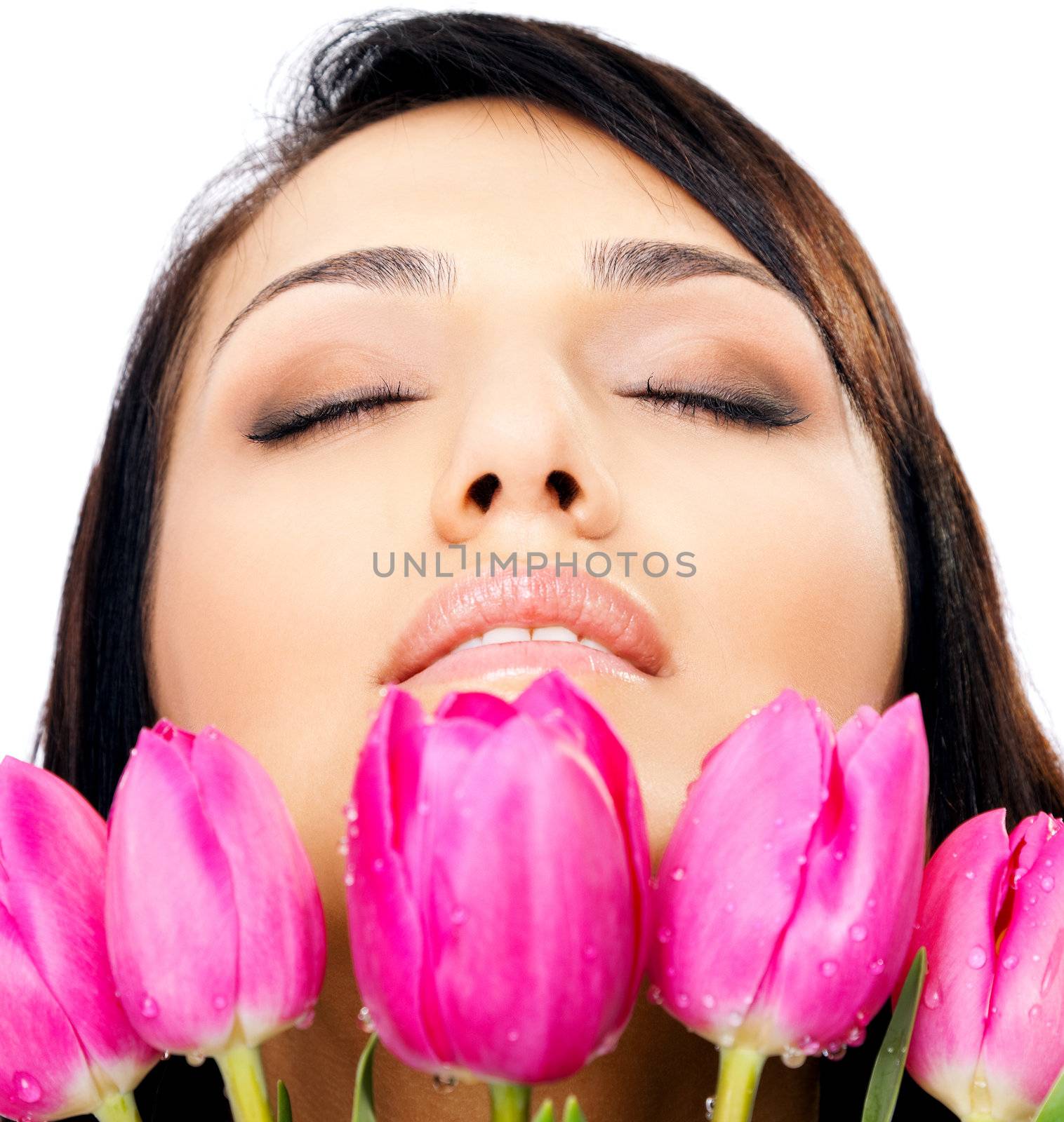 Beautiful young female face with pink tulips, eyes closed