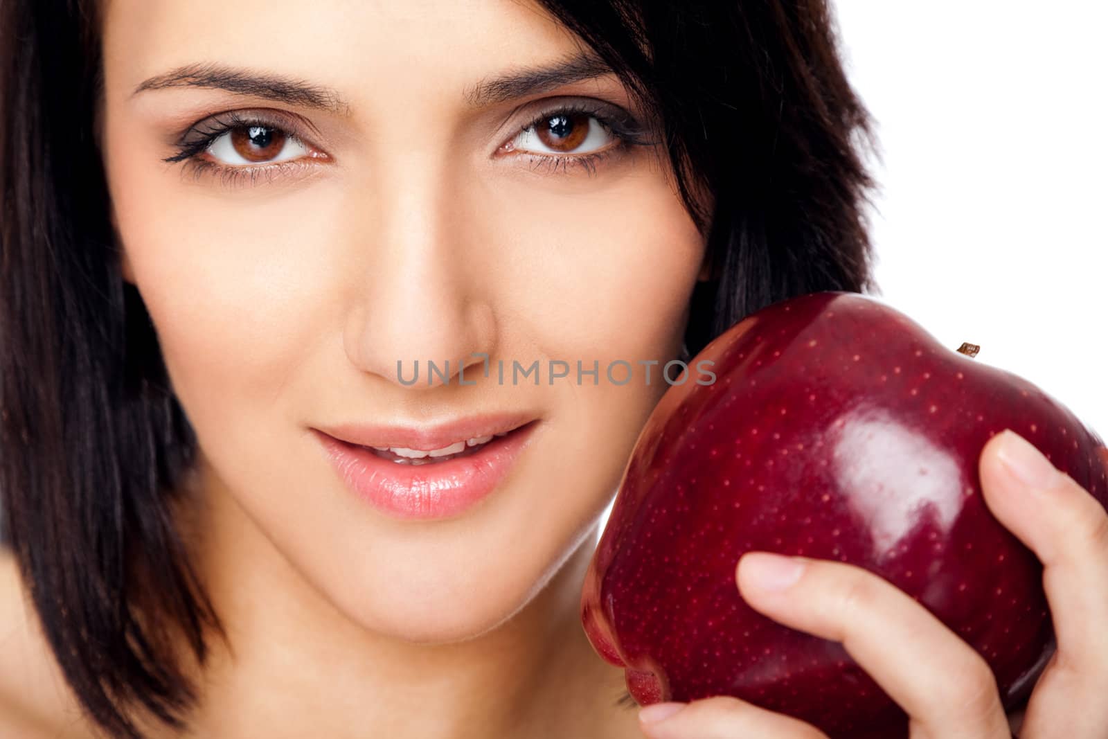 Portrait of beautiful female holding red apple, looking at camera