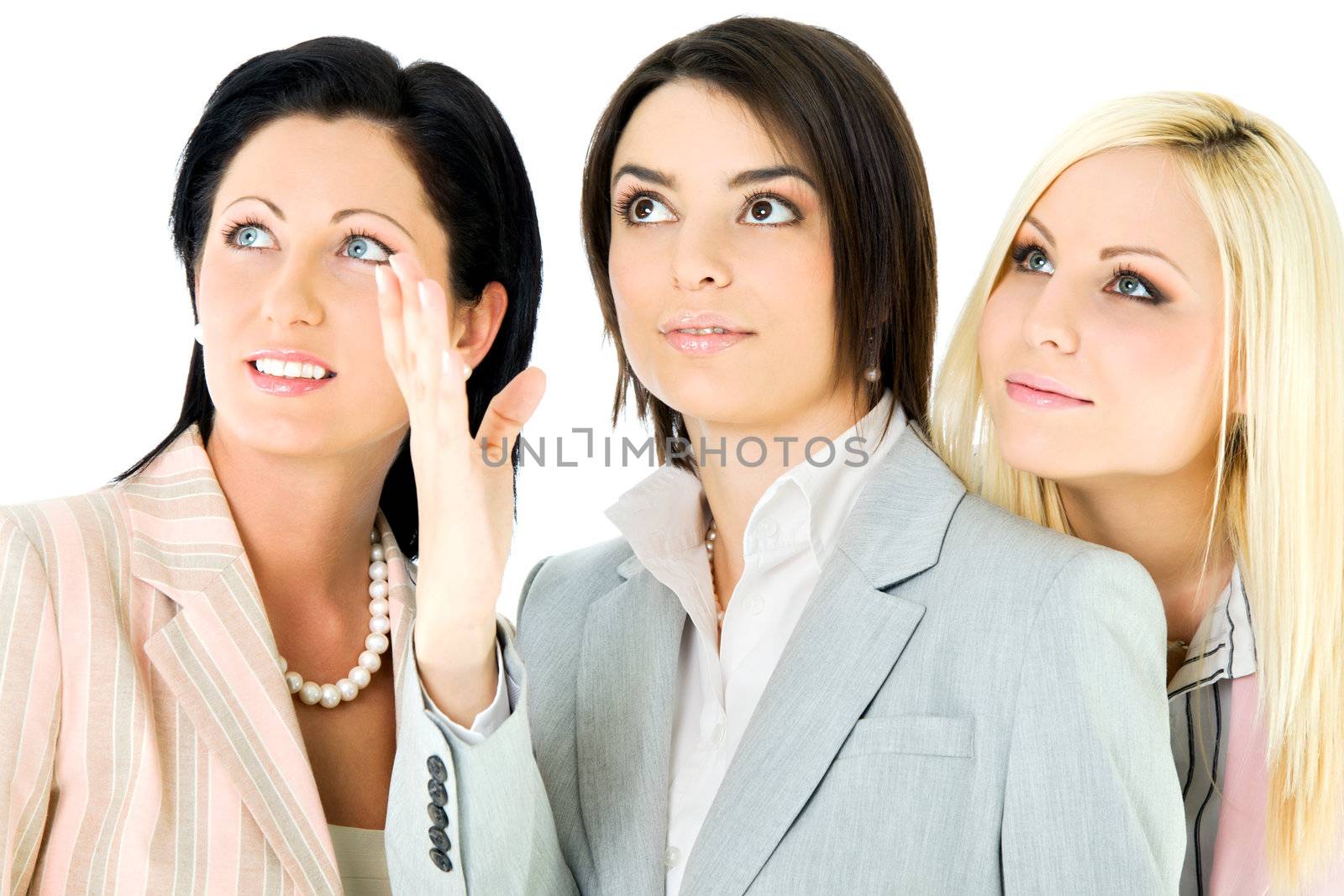 three beautiful businesswomen looking up, isolated on white