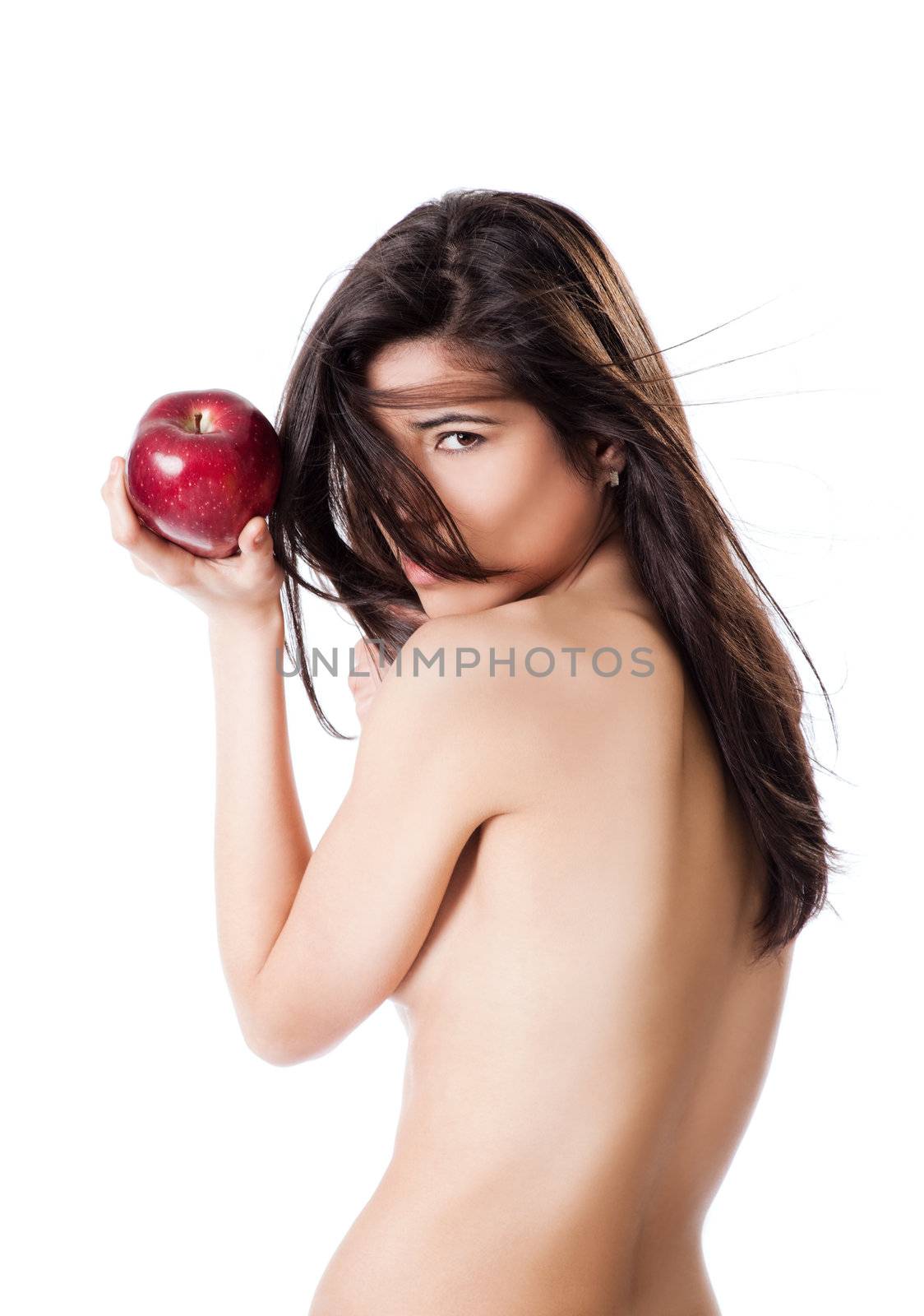 Beautiful topless female holding red apple in hand, looking at camera