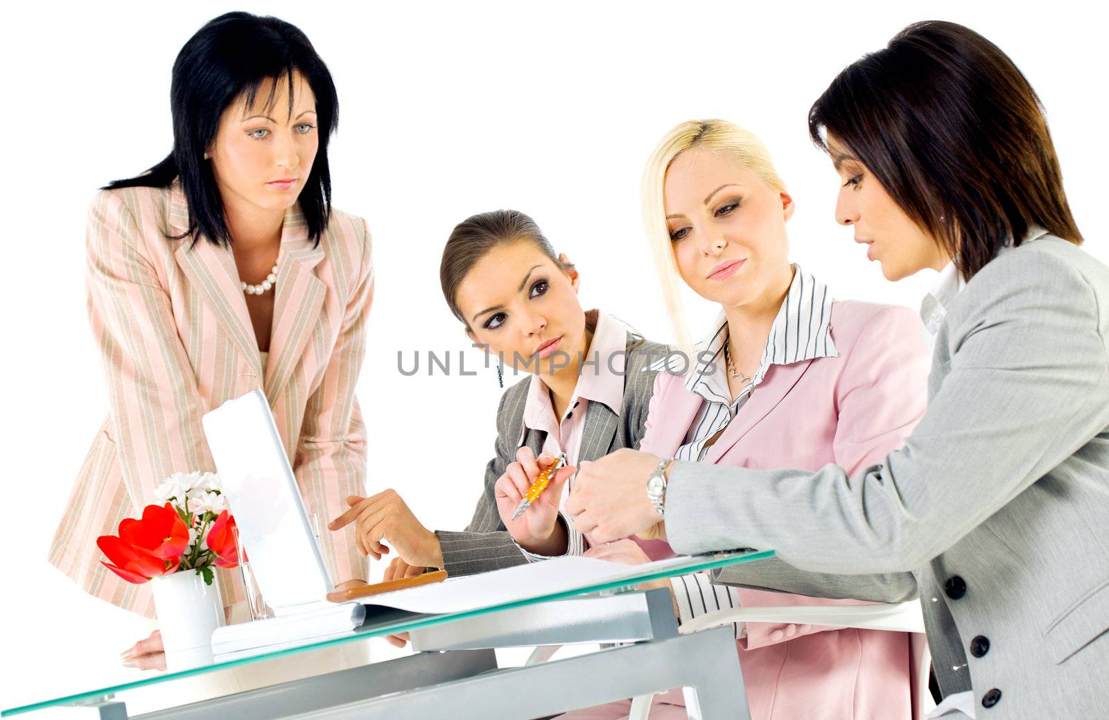 Team of four beautiful women working behind laptop