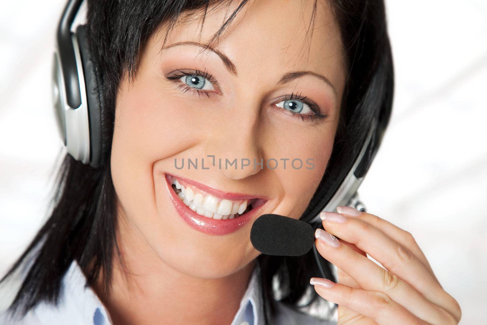 Portrait of young beautiful woman operator with headset, smiling