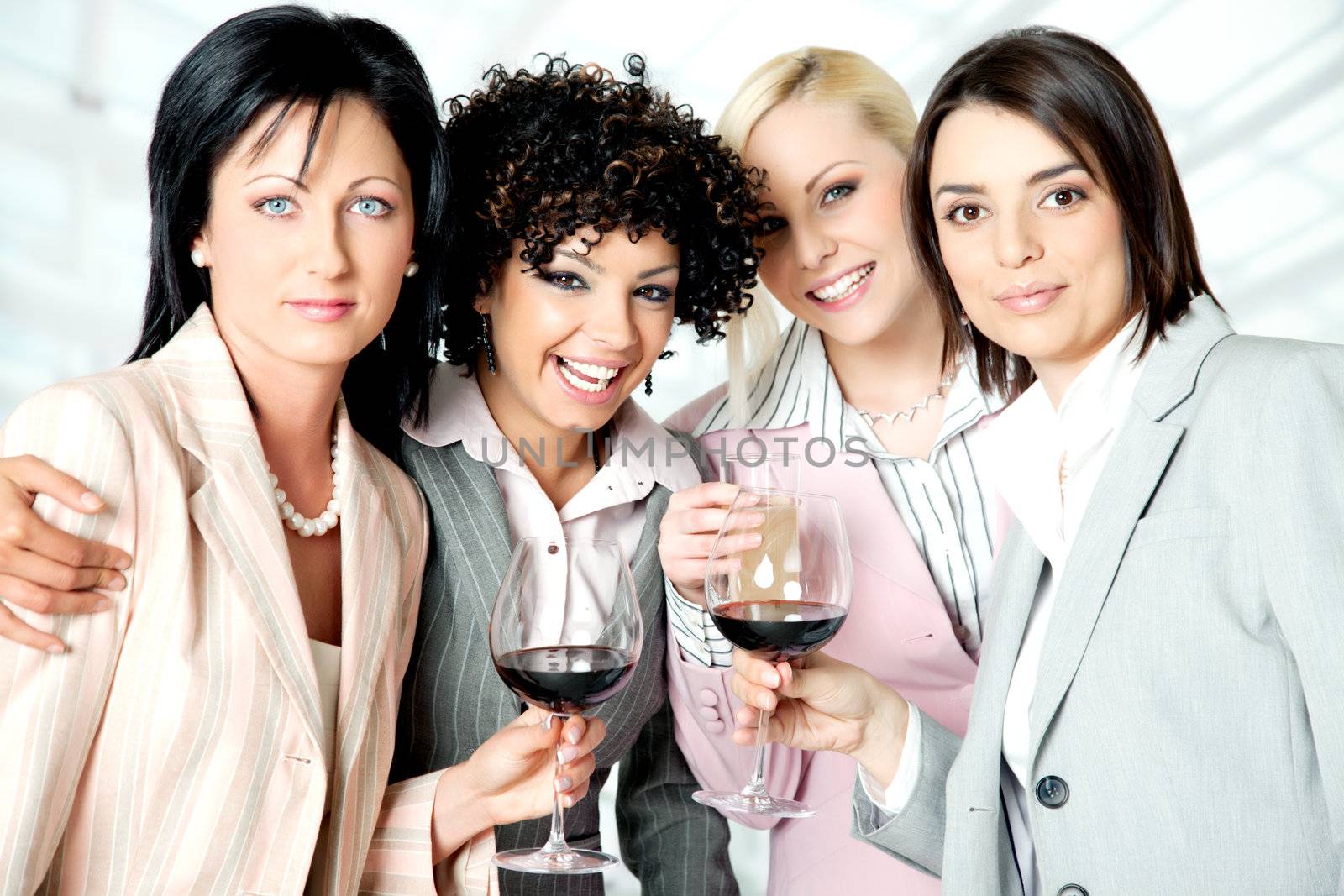 Team of four beautiful successful businesswomen celebrating
