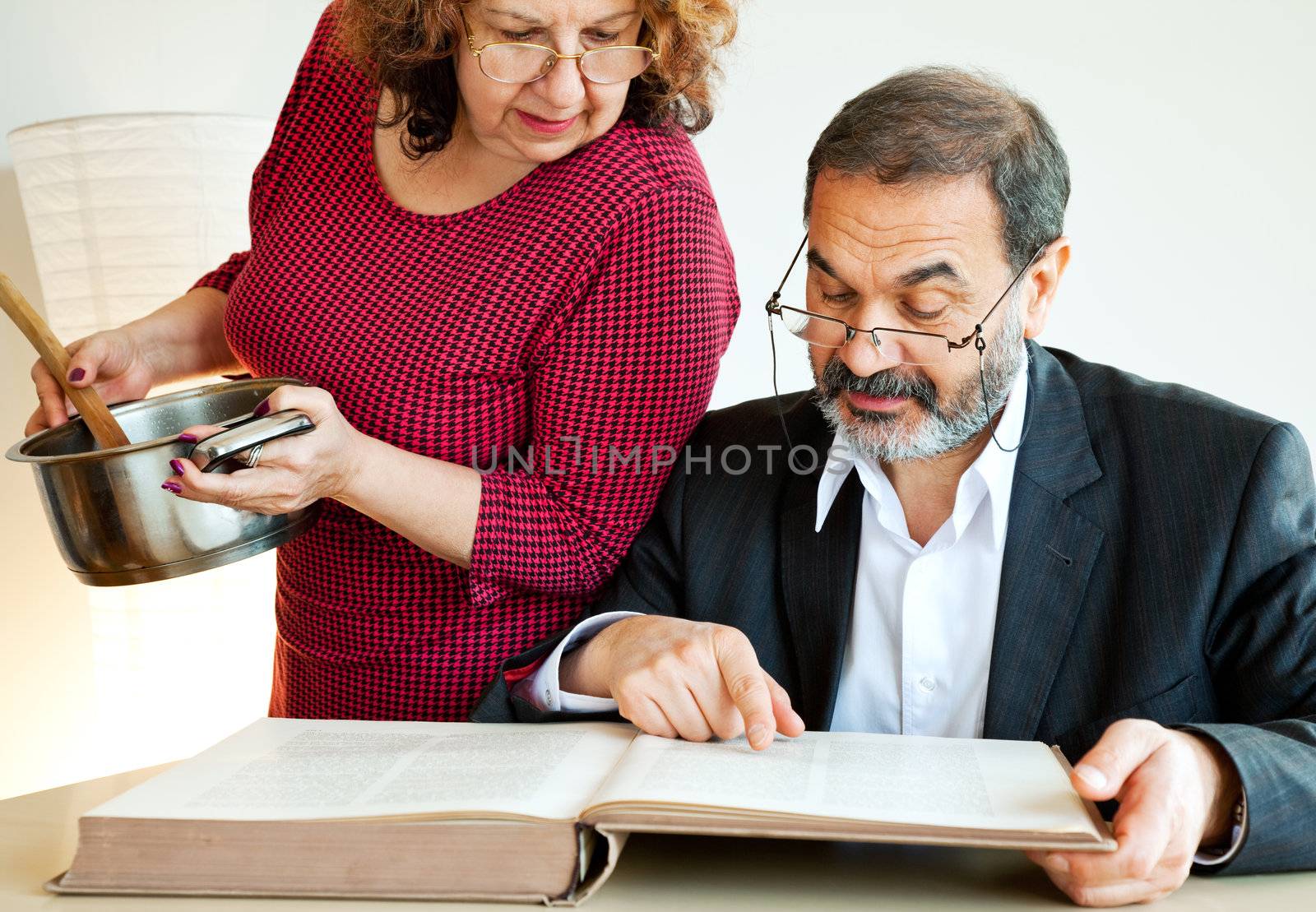 mature jewish brother and sister reading a book