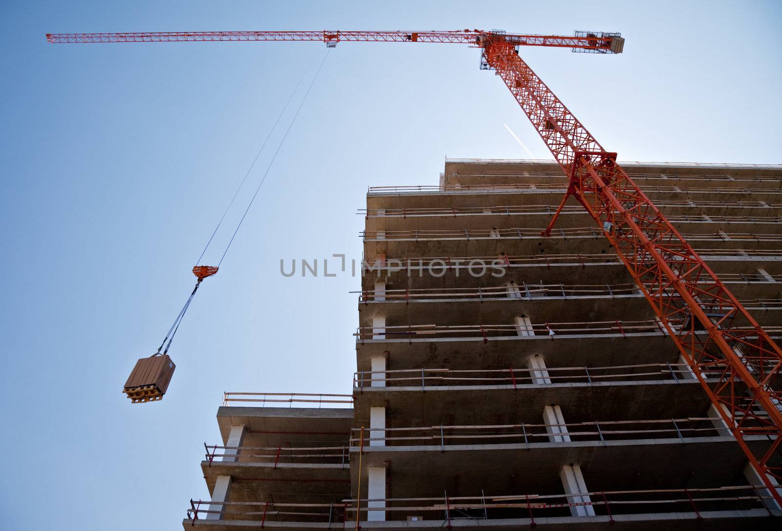 crane on a construction site by vilevi