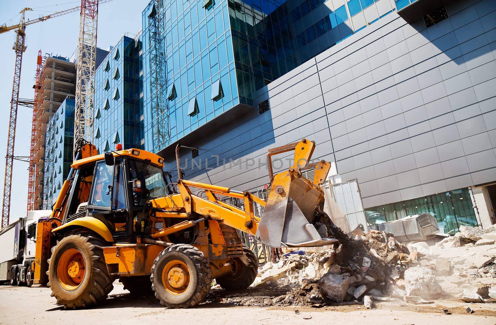 excavator on a construction site by vilevi