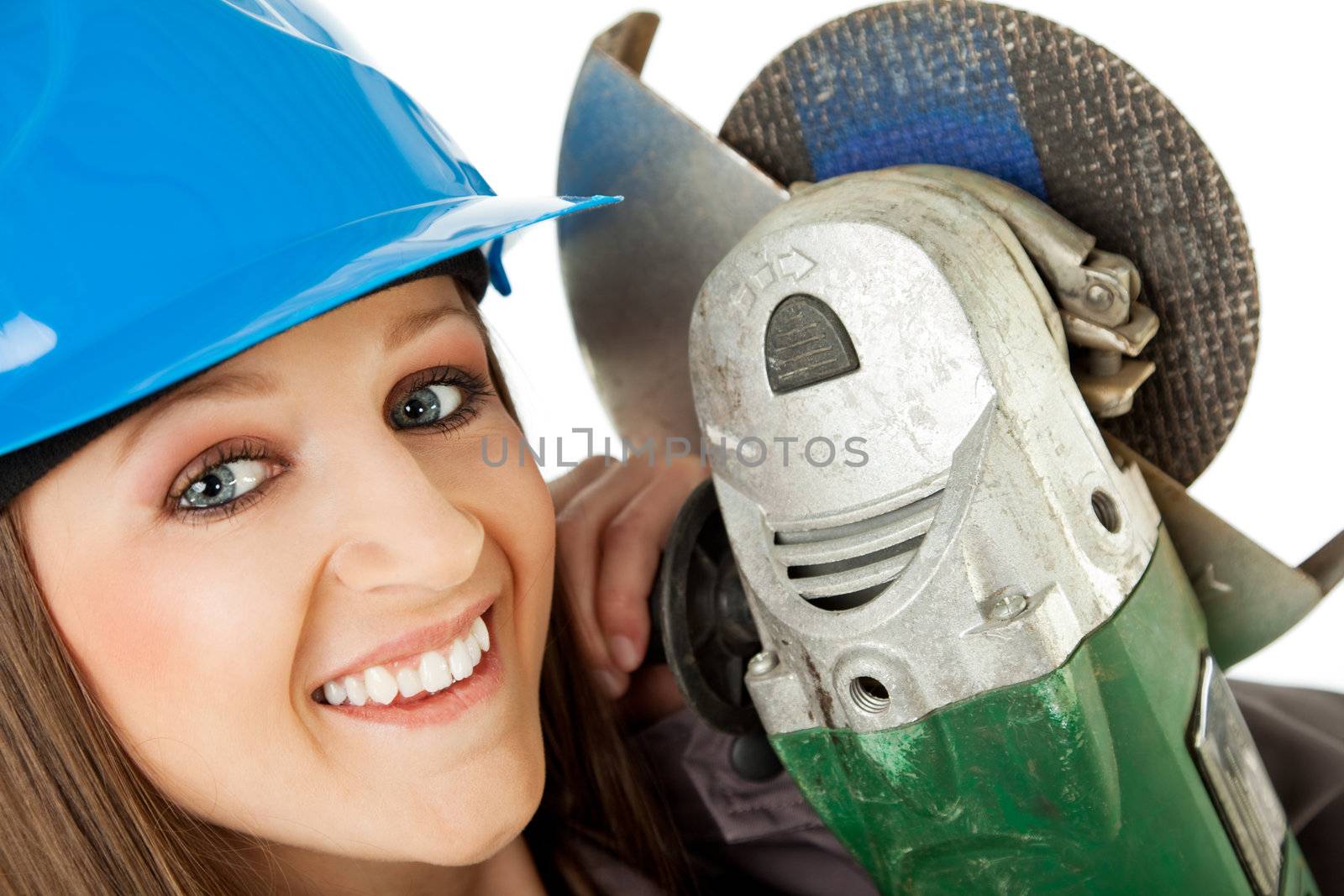 Close-up of beautiful happy female with blue hardhat holding grinder next to her face