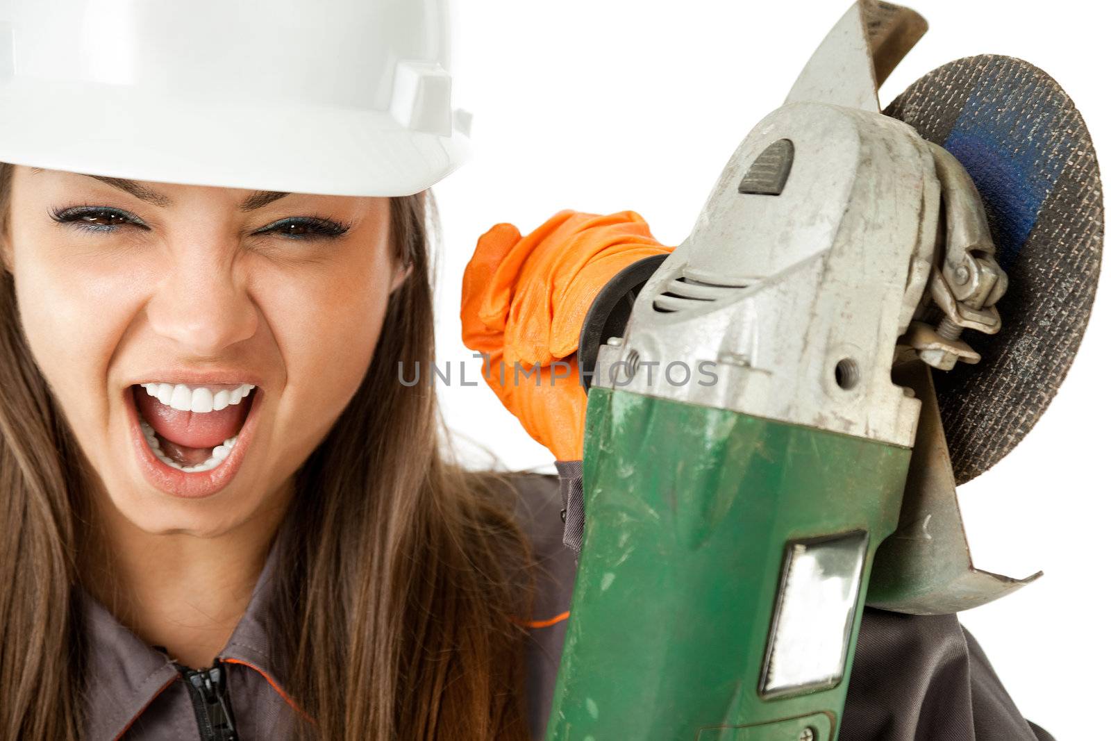 Close-up of female construction worker with hardhat screaming and holding grinder