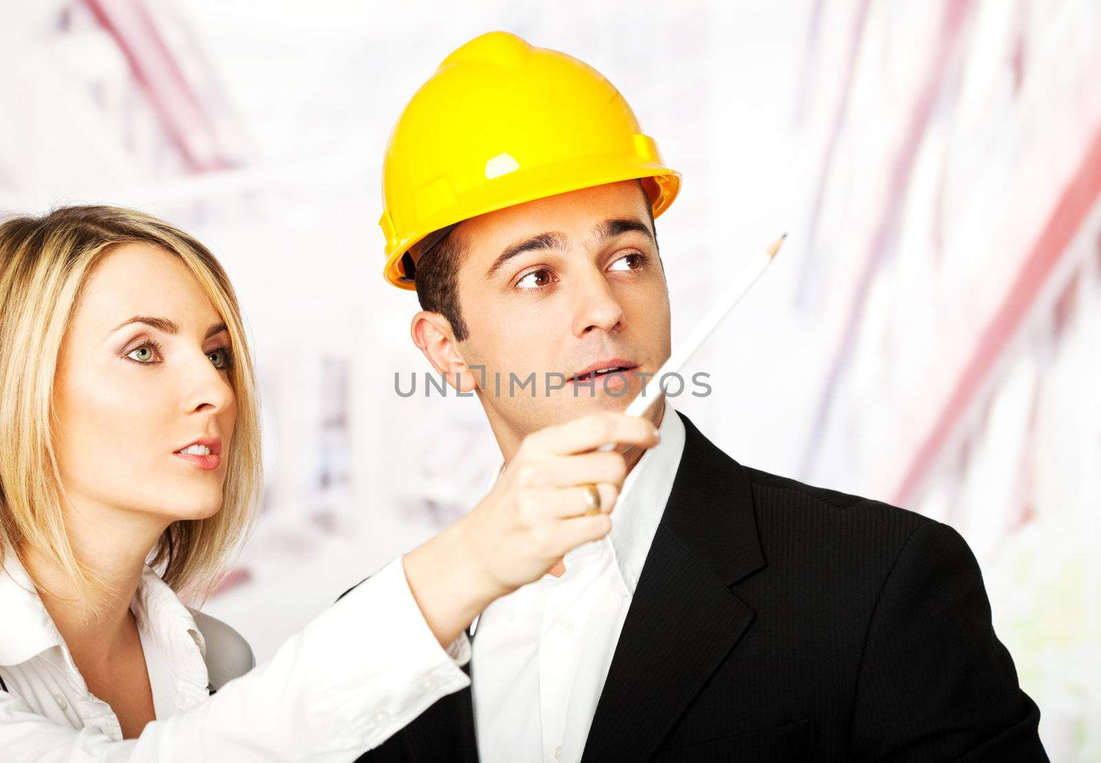 two young male and female architects or engineers discussing