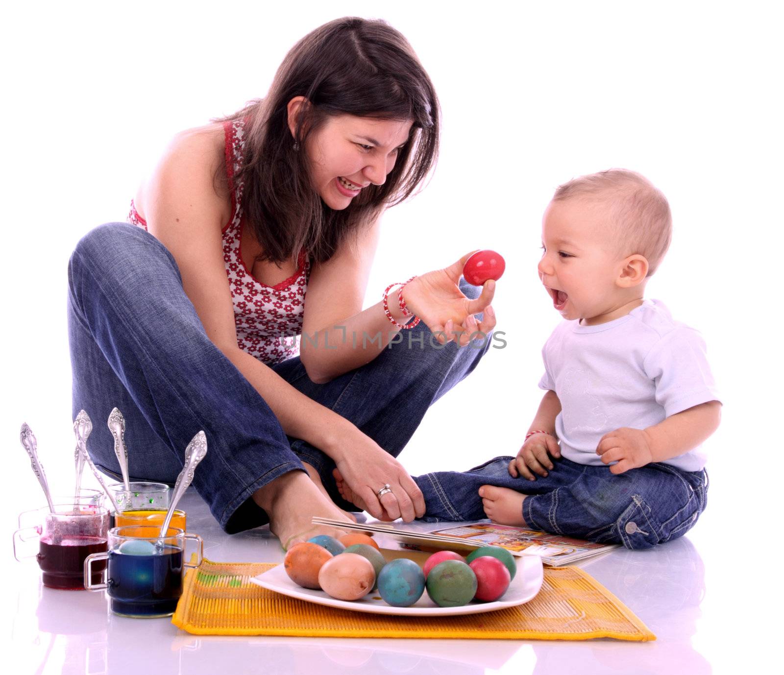 Happy mother and son preparing Easter eggs