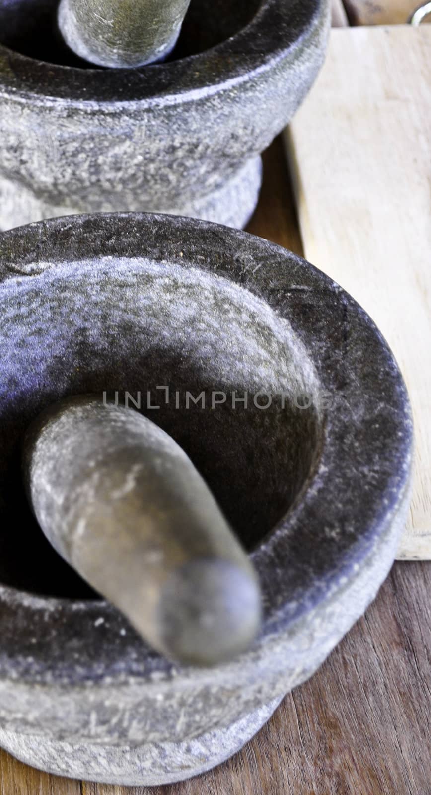 Two stone mortars and pestle used to grind spices in Thailand