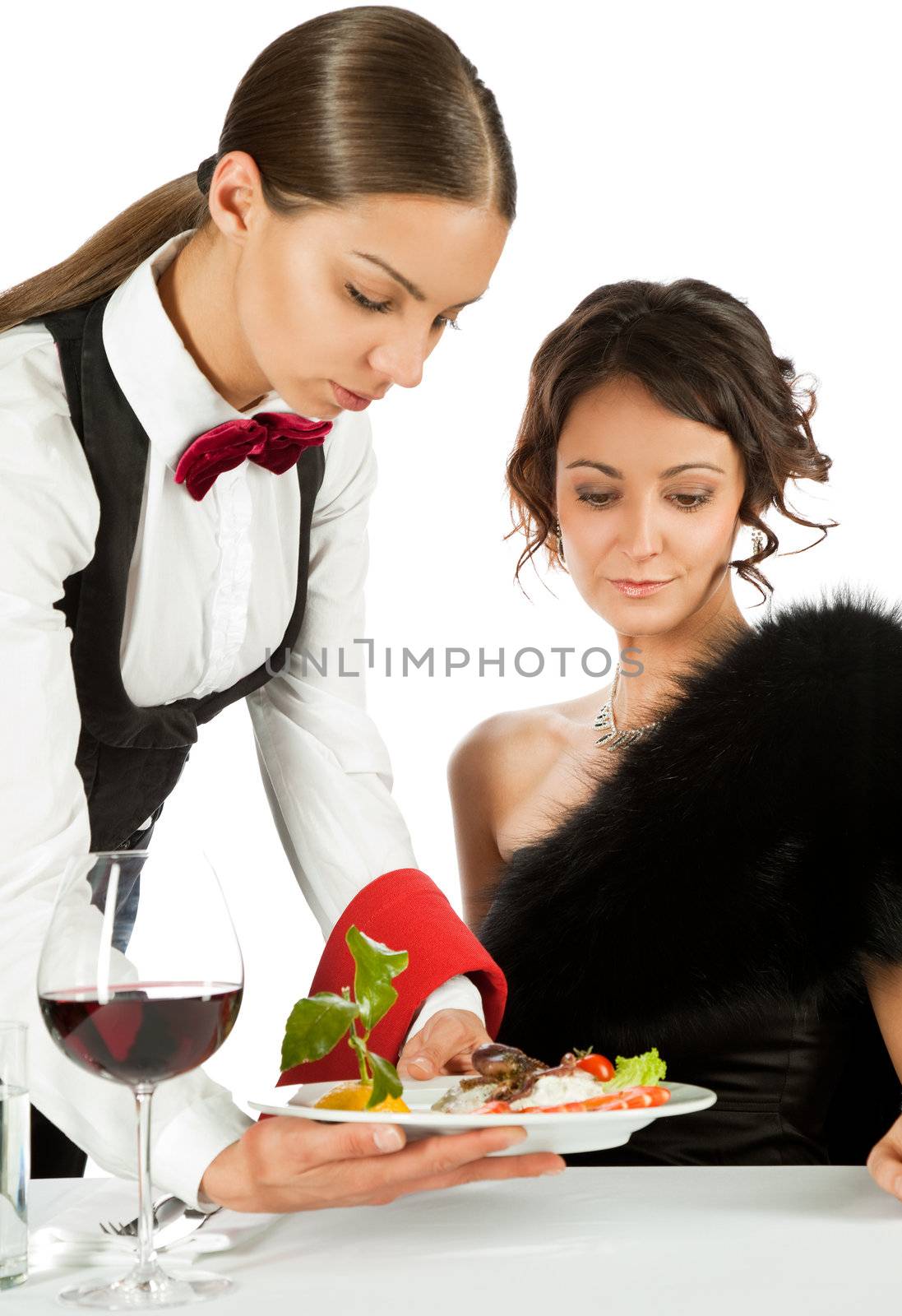 Young waitress serving seafood salad to elegant beautiful woman in restaurant