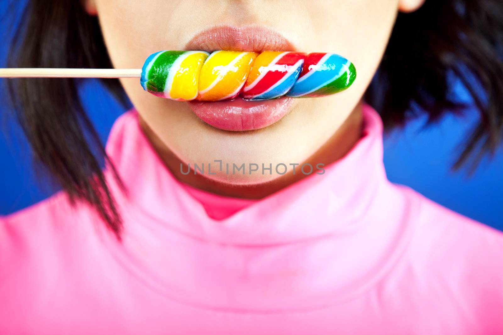 Close-up of a girl's mouth licking a lollipop