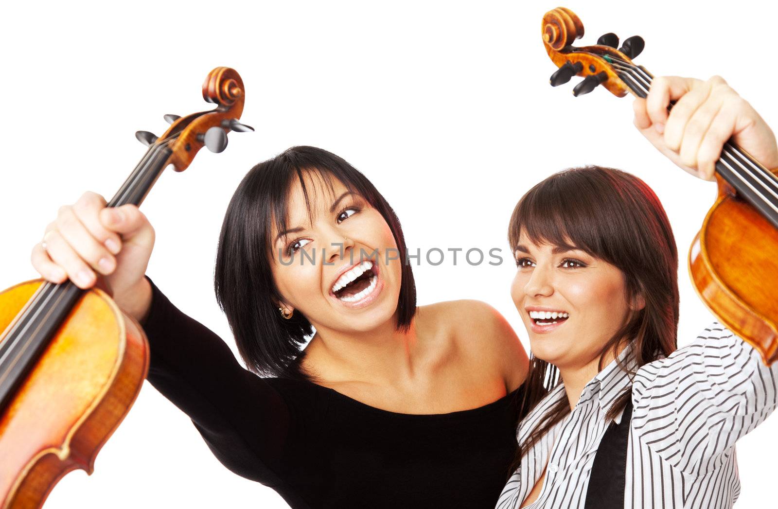 Two young excited female graduates holding up violins