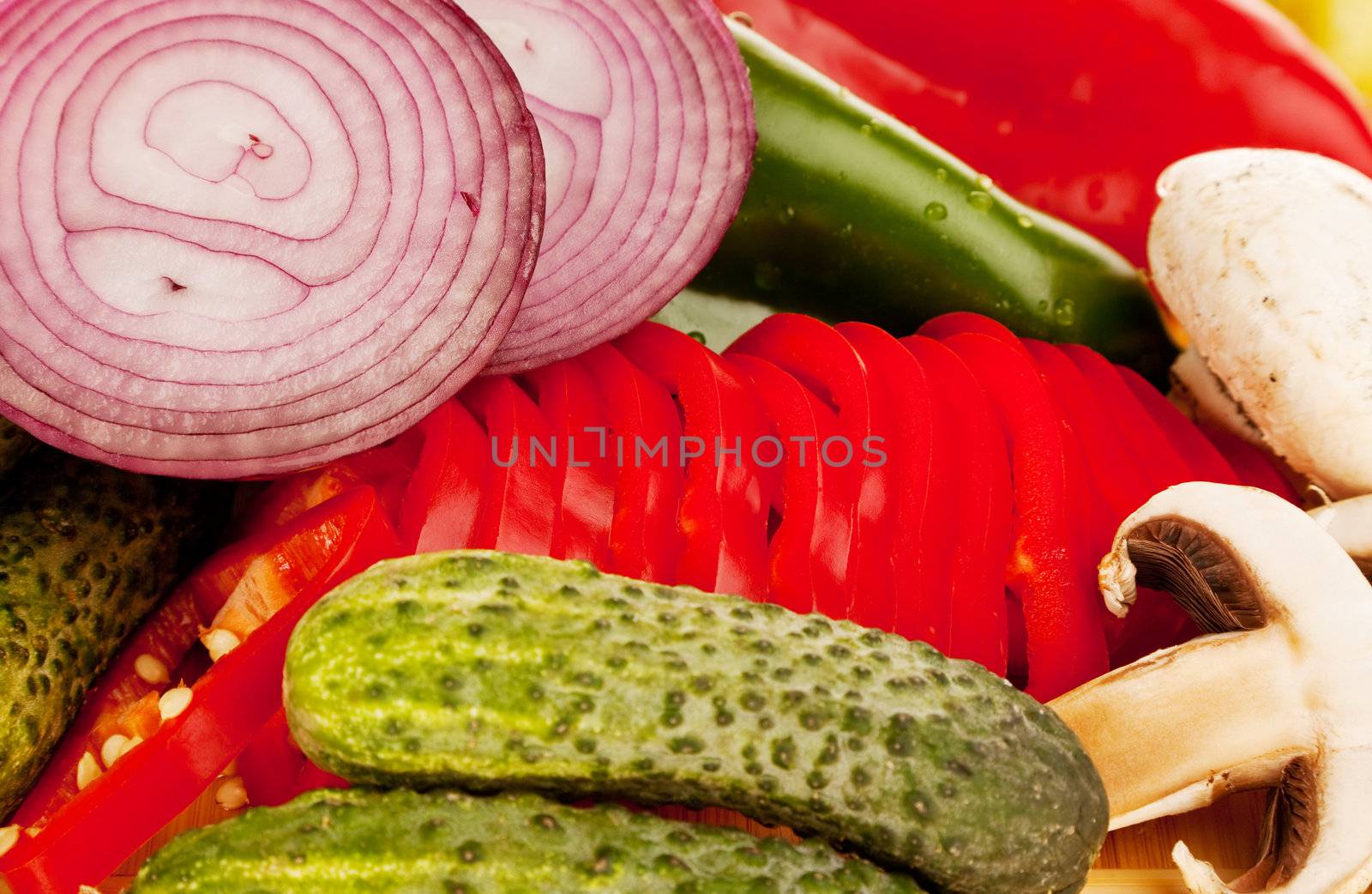 a group of vegetables : onion, peppers, small cucumbers, mushrooms
