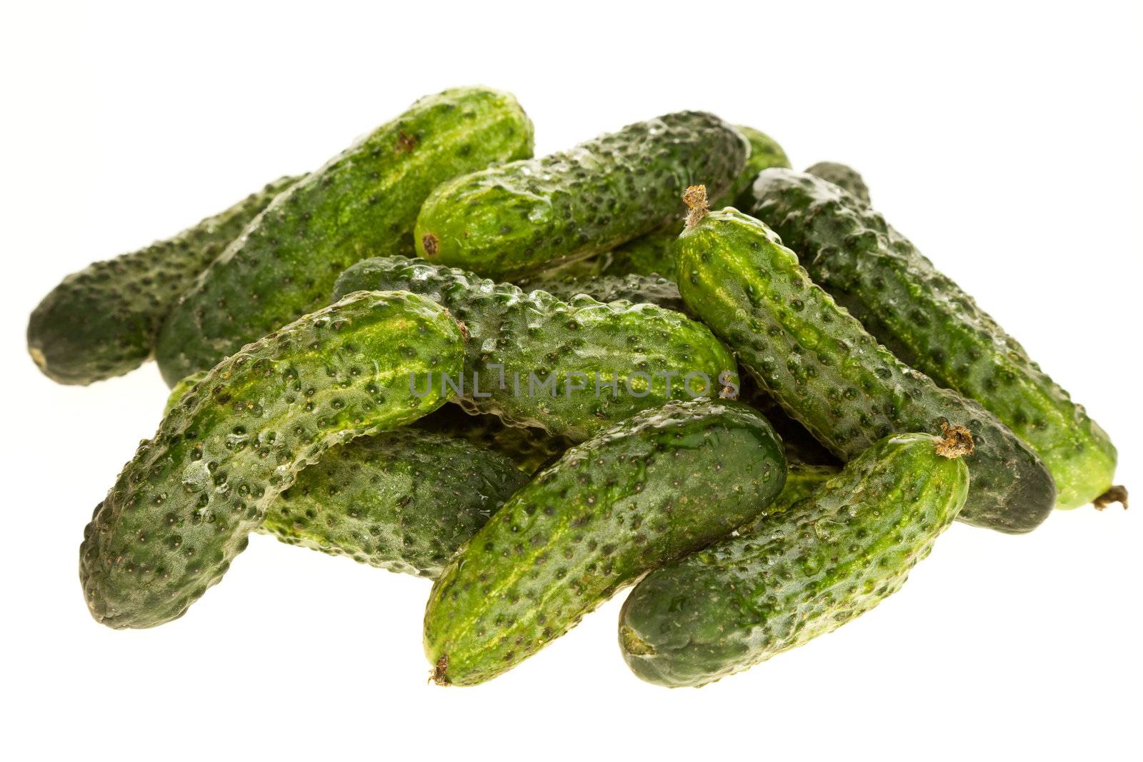 a bunch of small cucumbers isolated on white