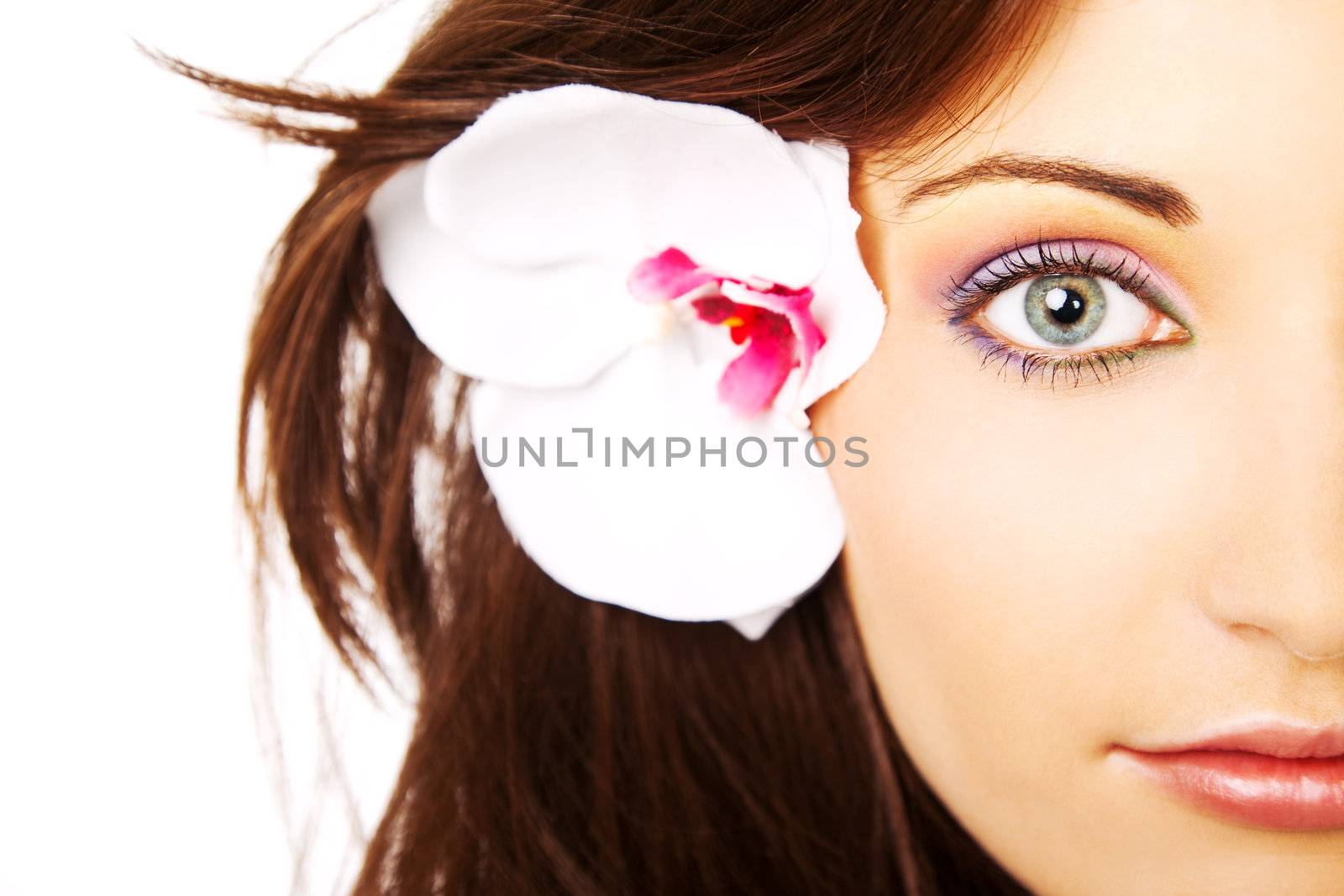 half face of a beautiful young female with artificial flower