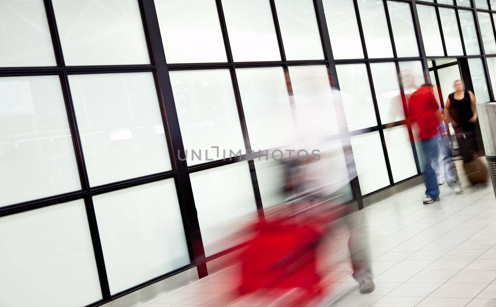 Blurred passingers airport by vilevi