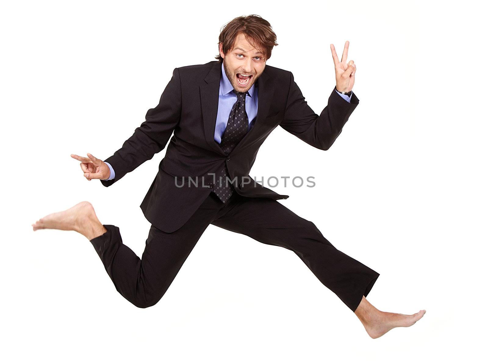 crazy dude in a suit, is jumping barefoot and making v-sign
