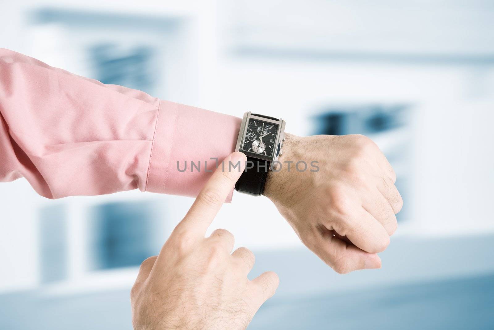 hands of the man with clock on urban background
