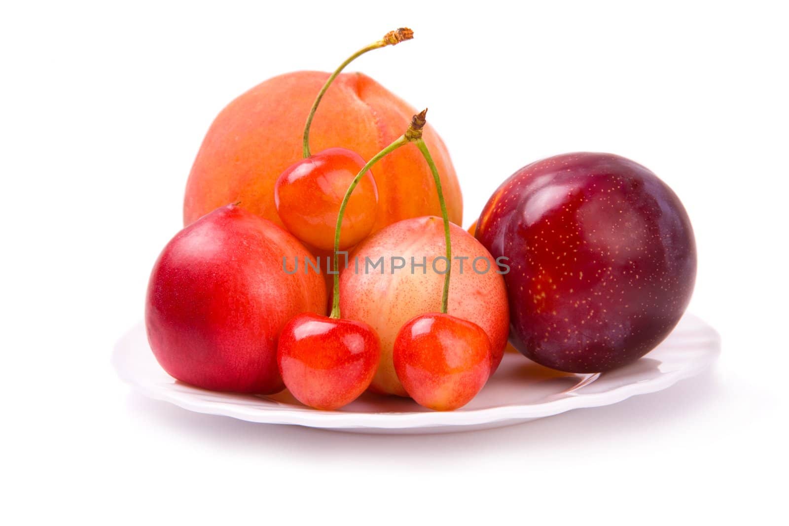 plate with fresh fruits isolated on white background