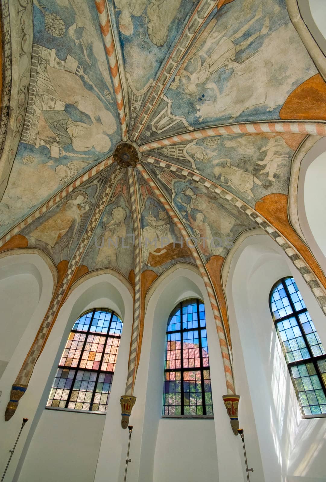 windows inside a church with frescos on the ceiling 