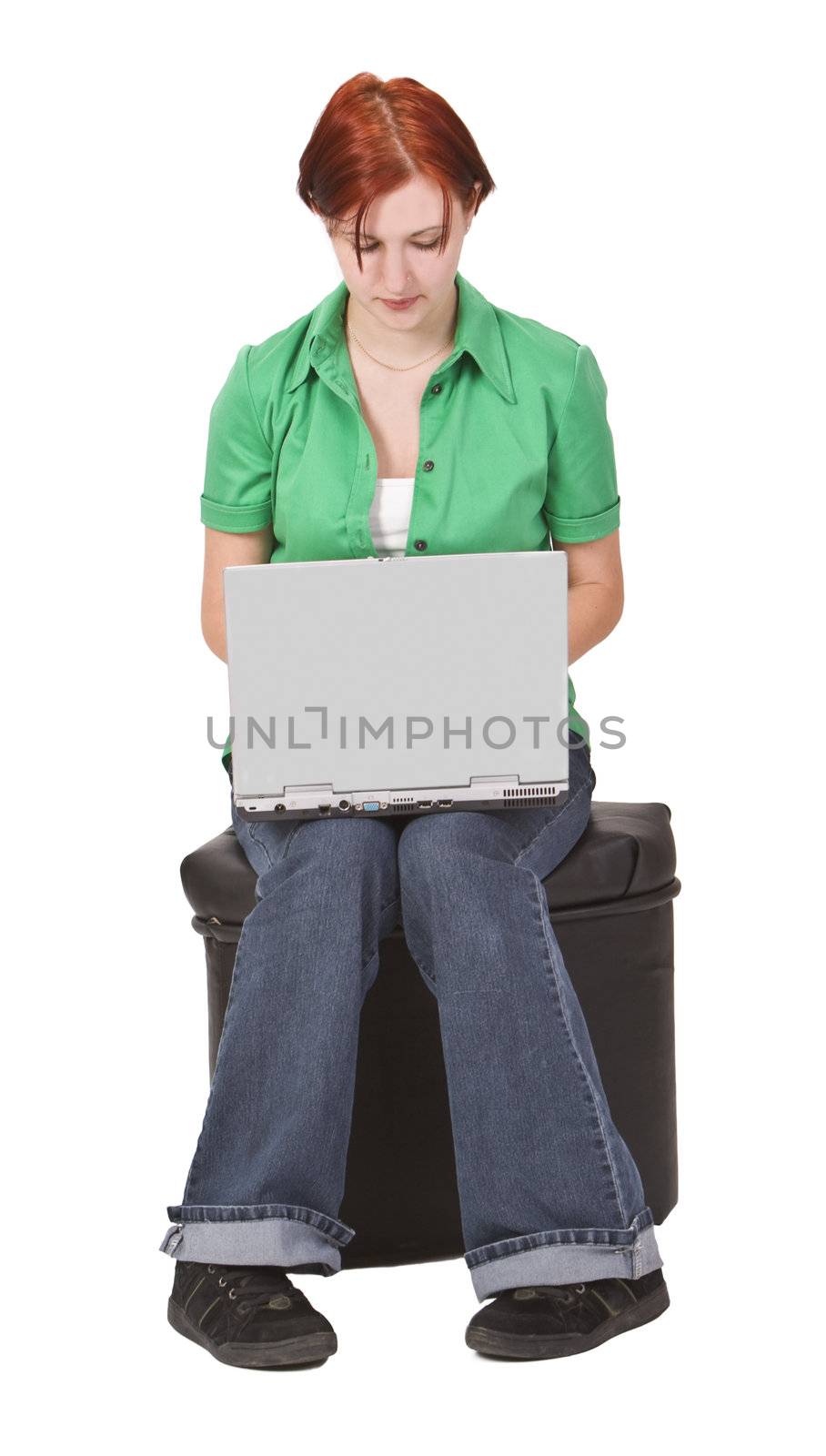 Image of a redheaded teen girl working on a laptop.Shot with Canon 70-200mm f/2.8L IS USM
