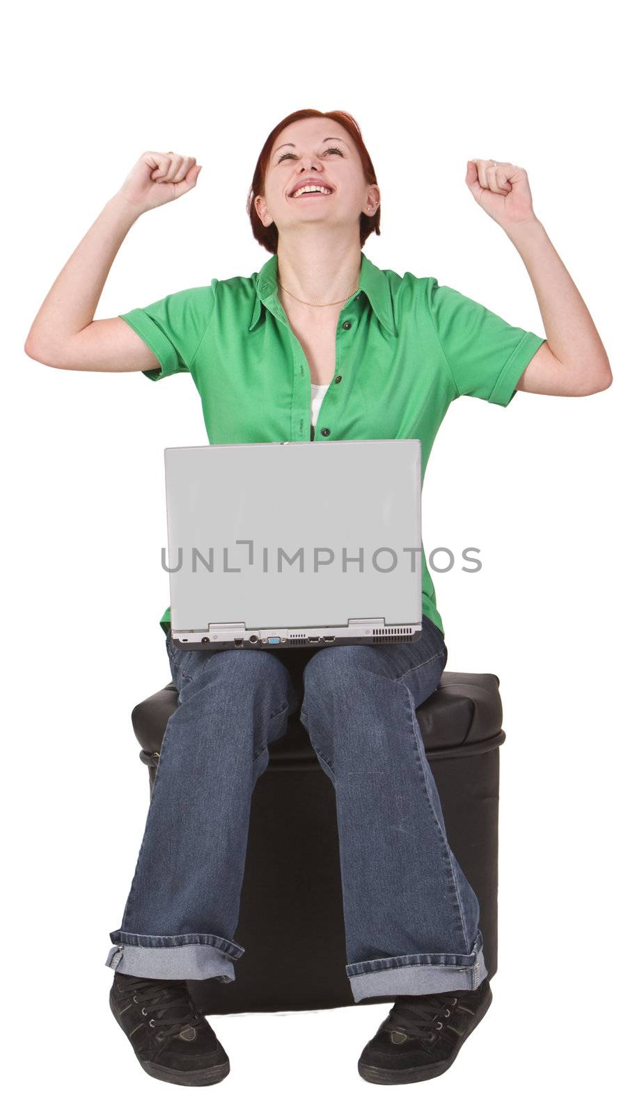 Image of redheaded teenager with a laptop expressing the feeling of victory.