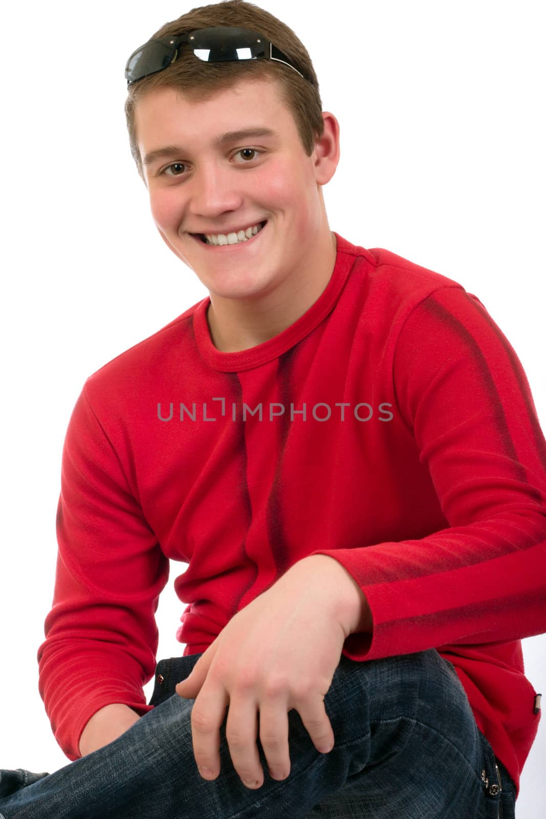 The sitting smiling young man